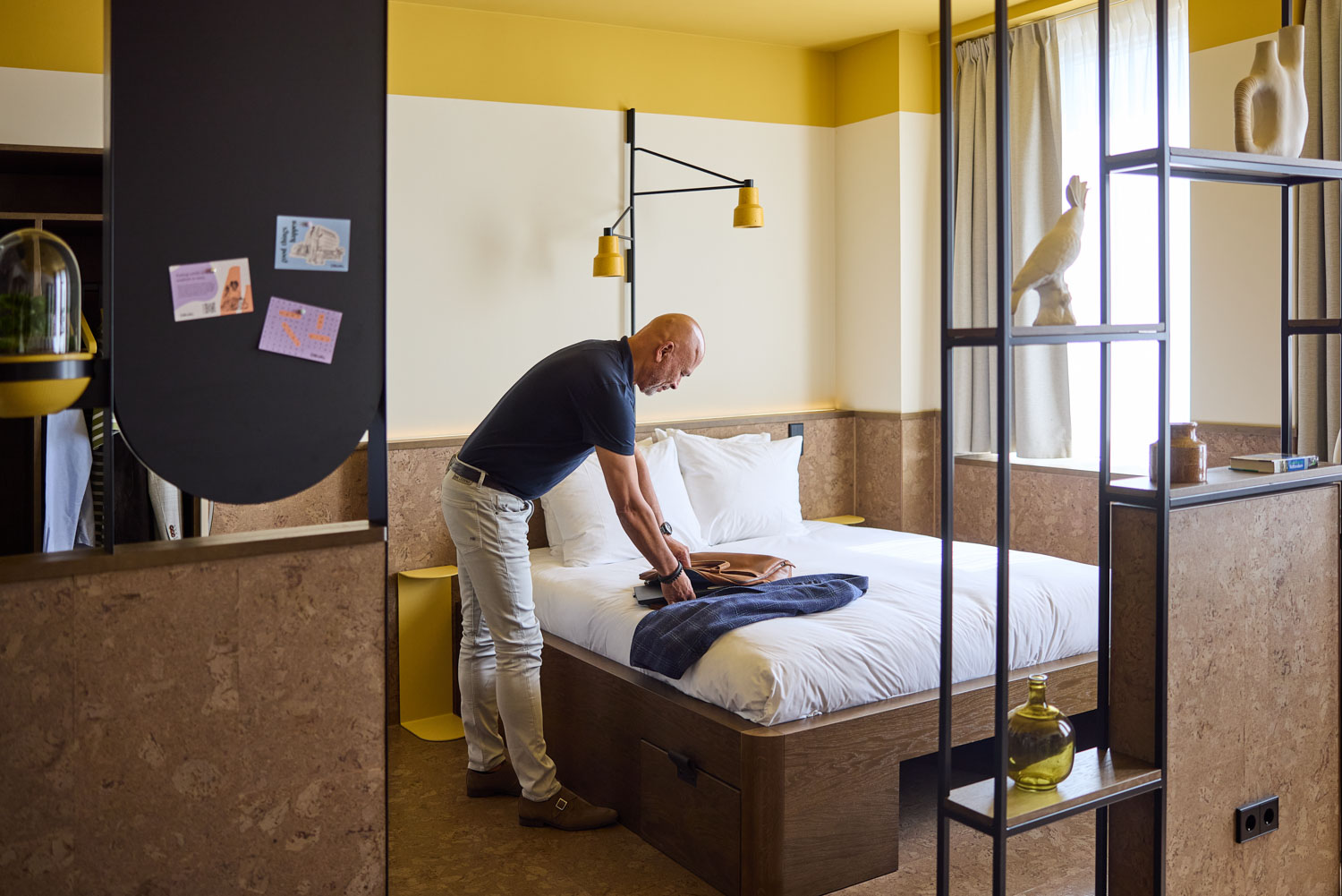 Man unpacking in The Studio at The Usual Rotterdam, a 4-star sustainable design hotel