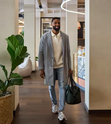 Man walking in lobby in 4-star sustainable design hotel The Usual Rotterdam